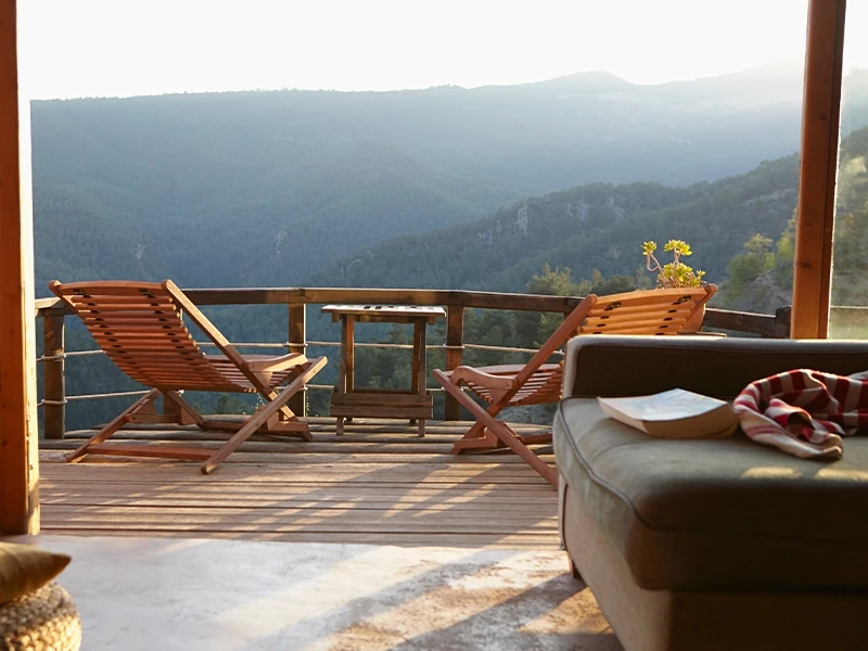 chairs on deck overlooking mountains